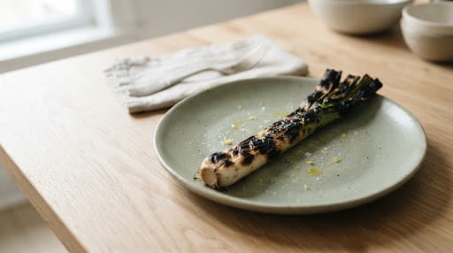 Charred leek on a ceramic plate